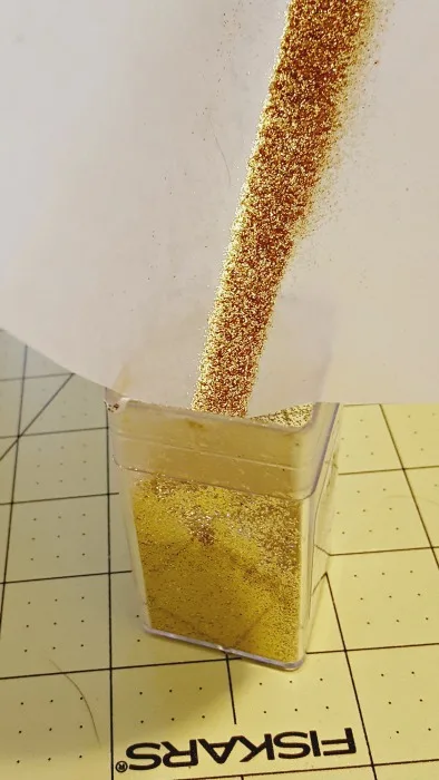 putting back extra glitter into container