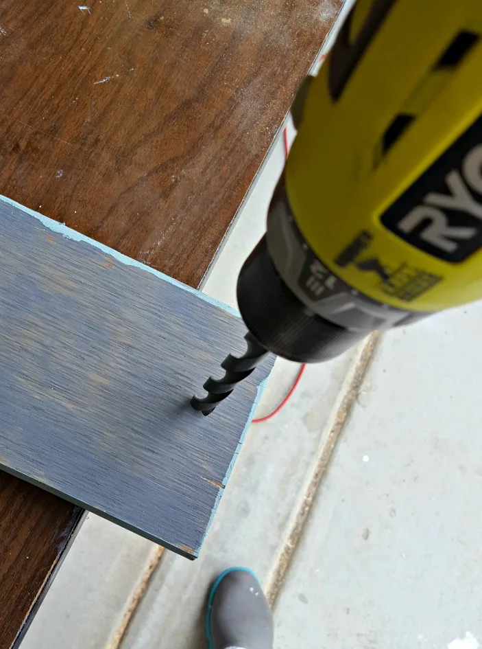 drilling hole into wood sign