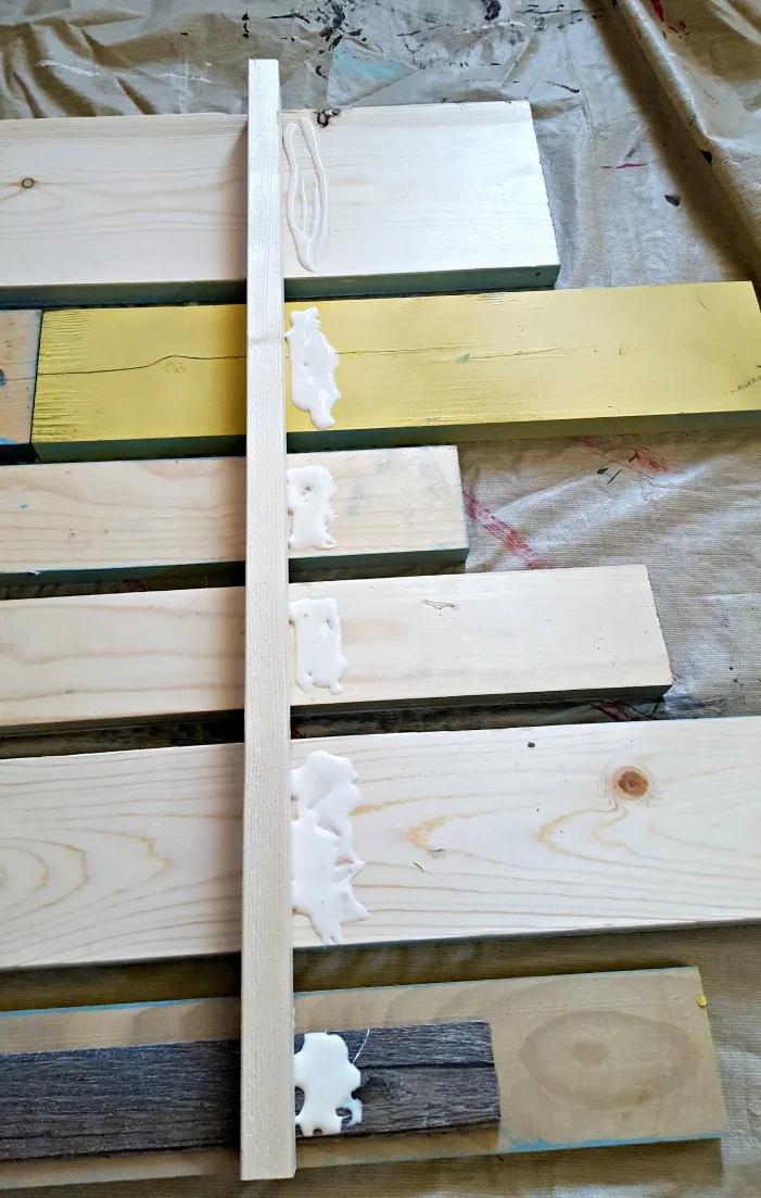 gluing boards on the back of a patio rules sign