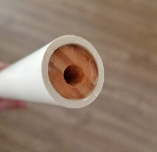inserting wood rod into PVC pipe