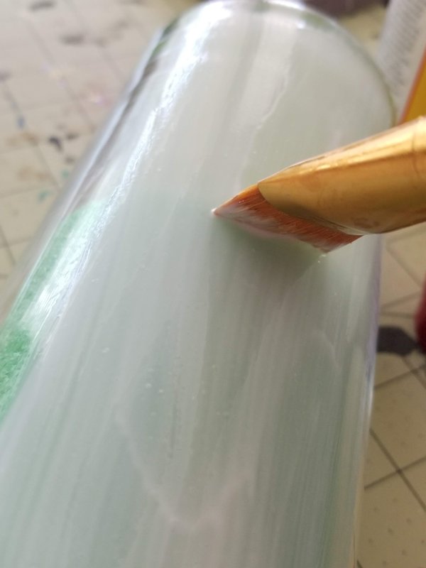 applying mod podge to glass for decoupage napkins 