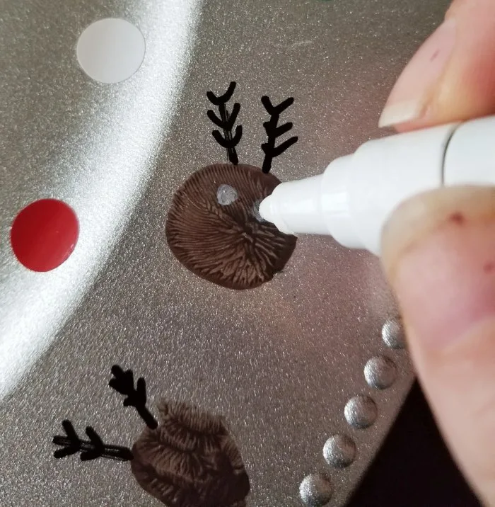 painting eyes on a reindeer with Sharpie
