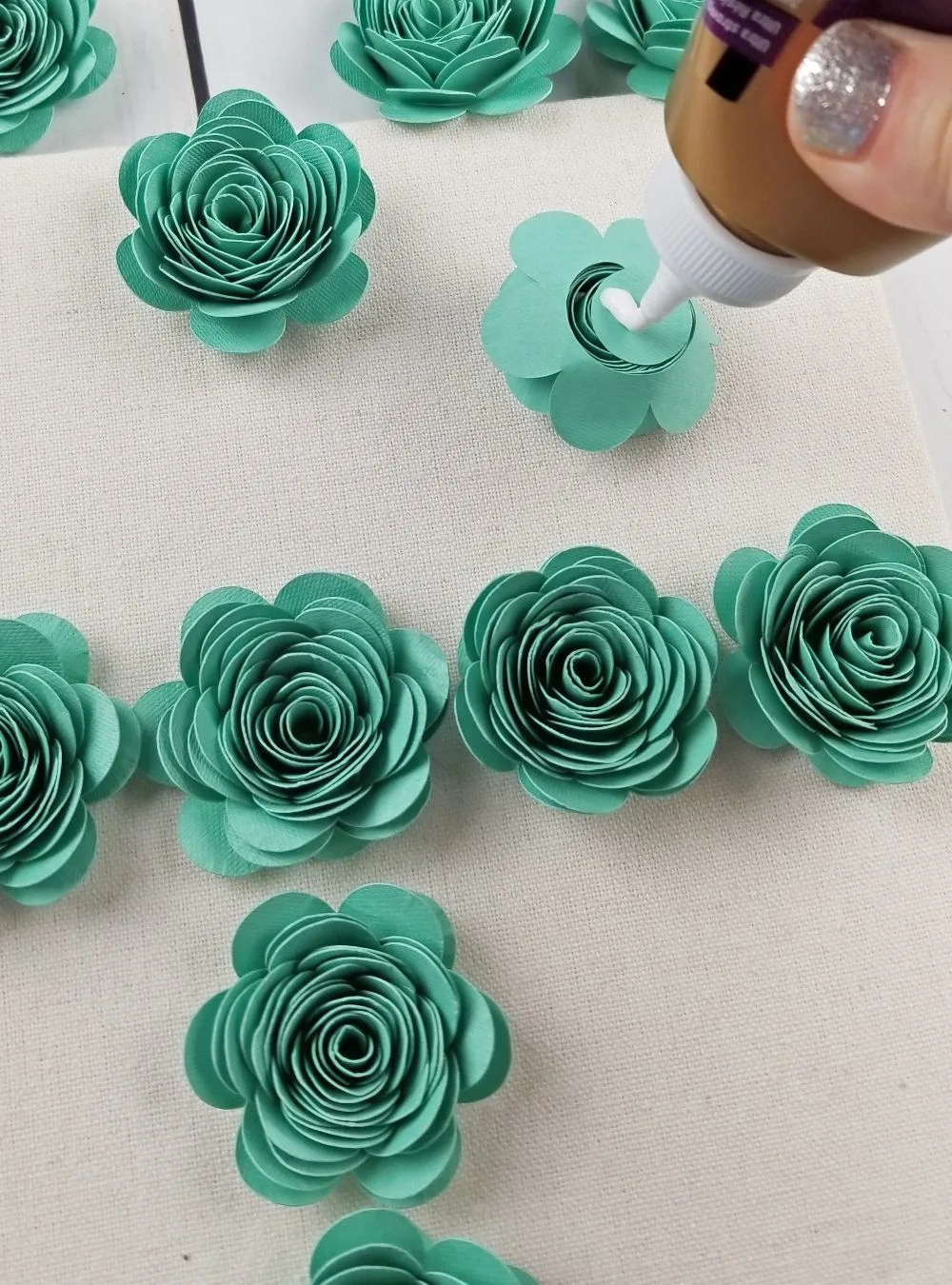 gluing paper flowers in shadow box